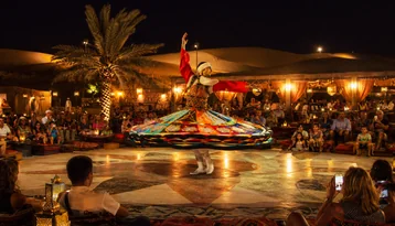 Traditional Tanoura performance at an Abu Dhabi desert camp evening experience