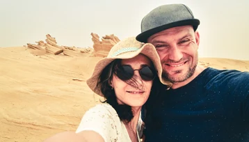 Couple taking a selfie among the Al Wathba Fossil Dunes during an Abu Dhabi desert tour