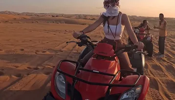 Guest riding a quad bike on the Abu Dhabi desert dunes during a self-drive ATV experience