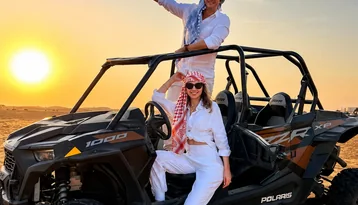 Guests with a Polaris dune buggy during a private morning desert tour in Abu Dhabi