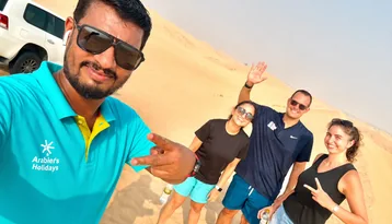 Arabiers guide with guests during a morning desert safari in Abu Dhabi