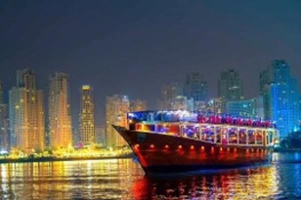 Traditional dhow cruise boat on Dubai Marina at night booked through Arabiers Holidays