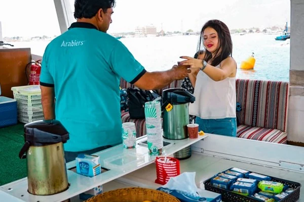 Arabiers Holidays guide assisting guests on a Musandam dhow cruise from Dubai