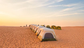 Desert tents prepared for an overnight camping experience in Abu Dhabi
