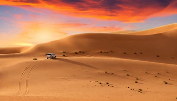 Guests photographing the Abu Dhabi desert during a standard evening 4x4 tour