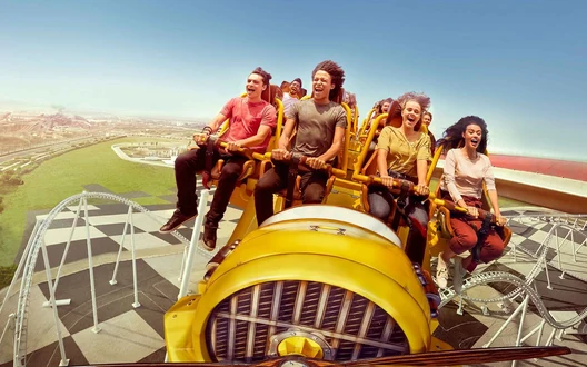 Guests enjoying a high-speed roller coaster at a Yas Island theme park in Abu Dhabi
