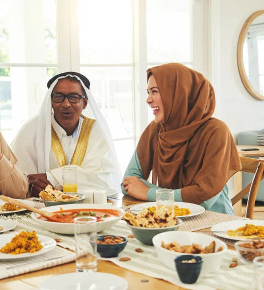 Arab family enjoying traditional Middle Eastern meal together at dining table