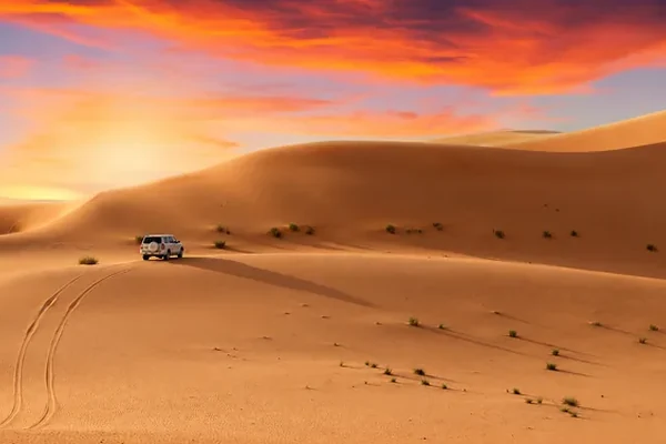 Sunset over the dunes on an evening desert safari from Abu Dhabi