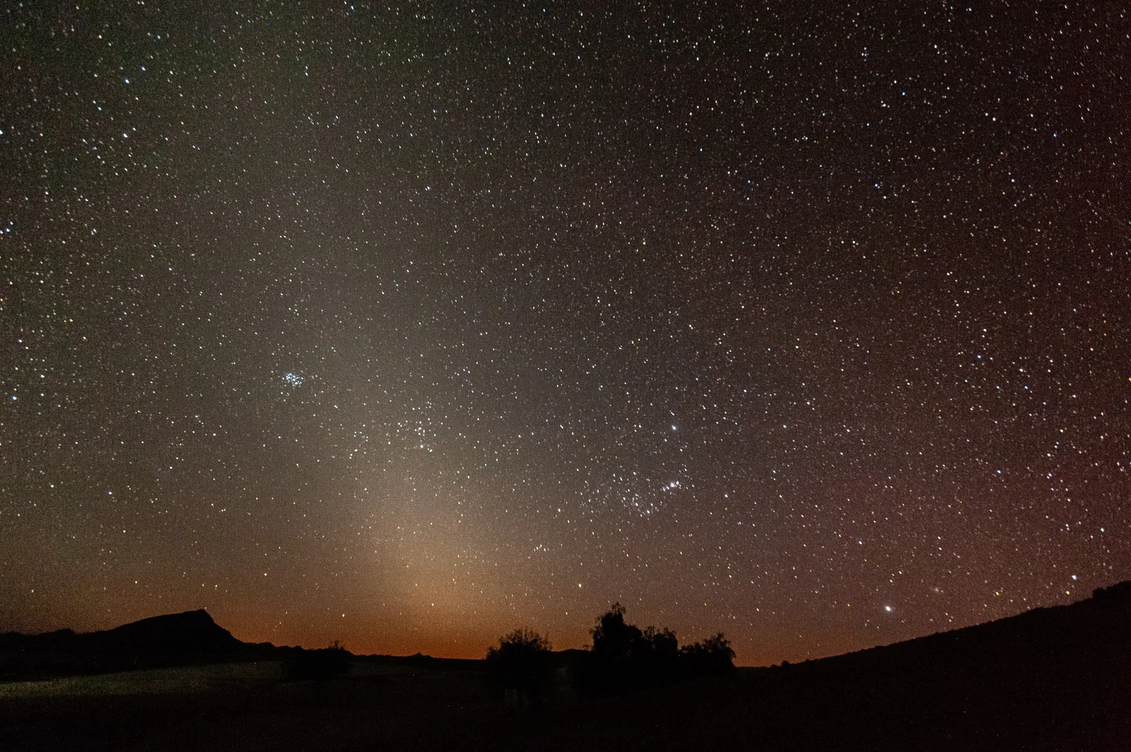 A quiet desert lake under a starry night sky