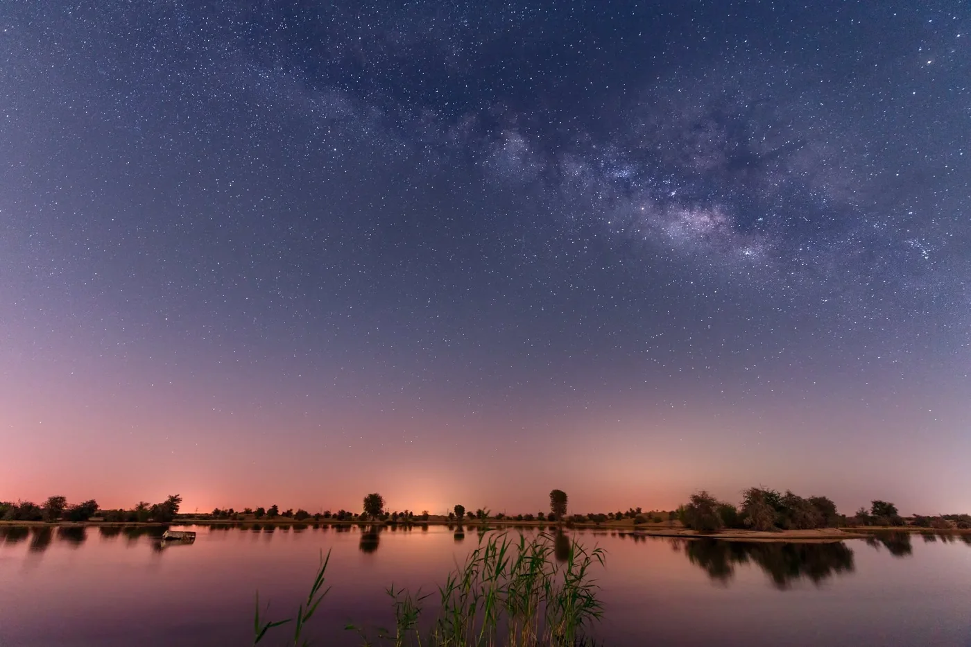 Starry night sky above a desert lake near Dubai