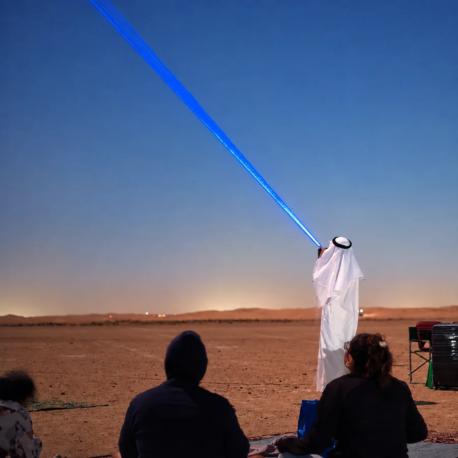 Astronomy guide using a laser pointer during a desert stargazing session