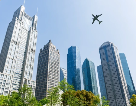 Abu Dhabi city buildings with an aircraft flying overhead
