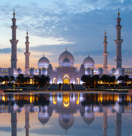 Sheikh Zayed Grand Mosque reflected in the water at dusk