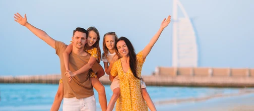 Family at the beach with Burj Al Arab in the background
