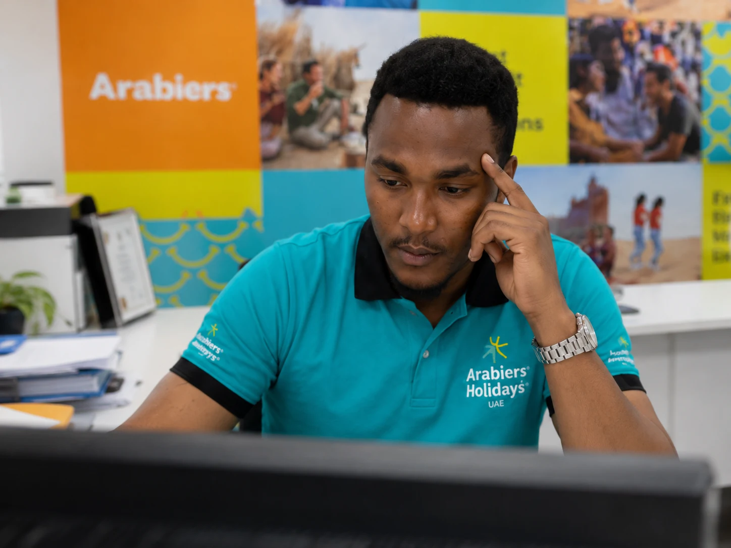 Don Max Mutuma reviewing a complex visa file at the Arabiers Dubai visa desk