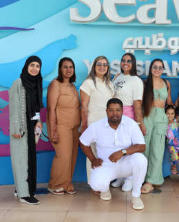 Khadija Nasir with an Arabiers Holidays family tour group at the SeaWorld entrance on Yas Island, Abu Dhabi