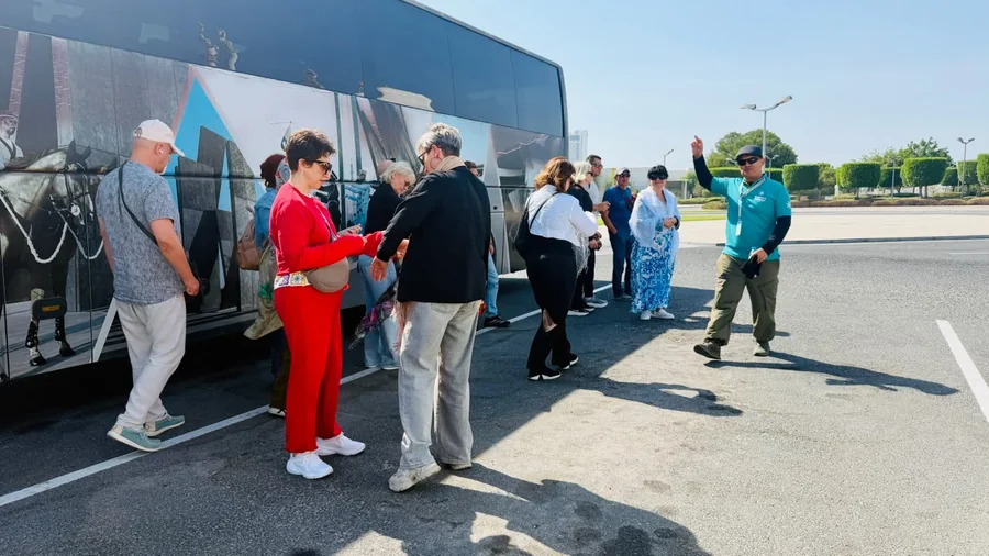 Khurshed Kamalov in Arabiers Holidays uniform directing tour guests boarding a coach in Abu Dhabi