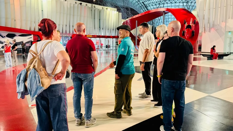 Khurshed Kamalov, DCT accredited guide, briefing a tour group inside Ferrari World Abu Dhabi