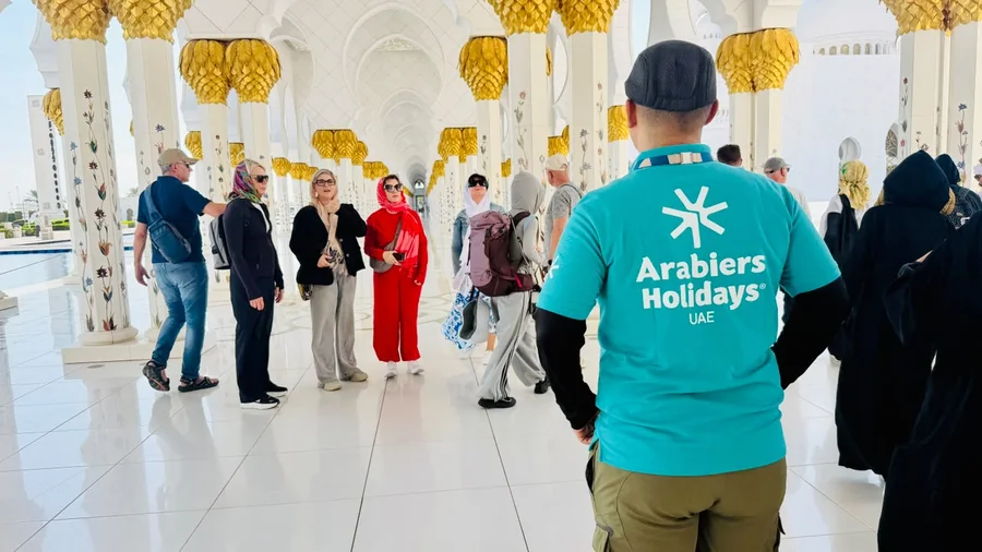 Khurshed Kamalov guiding an Arabiers Holidays group in the courtyard of Sheikh Zayed Grand Mosque, Abu Dhabi