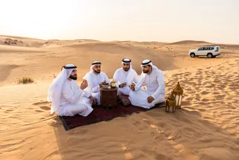 Traditional Arabic coffee gathering in the Liwa dunes, reflecting the cultural side of a Liwa day tour led by Mujeeb Rahman for Arabiers Holidays