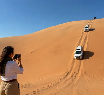 White 4x4 parked on Liwa desert dunes at sunset, Liwa Desert Safari guide by Martin Muthugumi for Arabiers