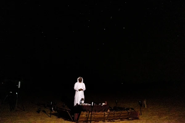 Mahmood Hasan leading a laser-guided constellation talk with guests in the UAE desert