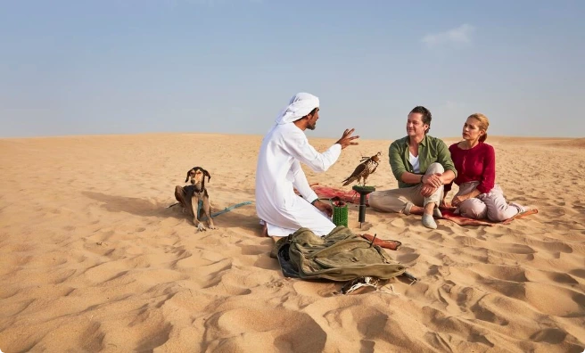 Arabiers desert guide with guests during a private desert experience in Abu Dhabi