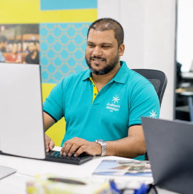 Sohail Ahmed, UAE Visa & Travel Operations Manager, processing UAE visa applications at his desk in the Arabiers Holidays office in Dubai