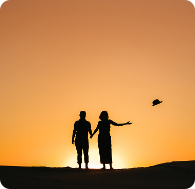 Couple silhouette at sunset during destination desert wedding in Dubai sand dunes