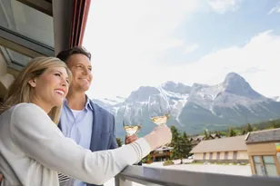 Couple at a Canada mountain hotel with scenic views, selected by Arabiers for Canada hotel booking guidance from the UAE