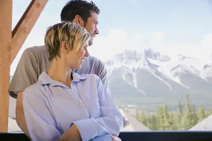 Couple at a Canada mountain hotel with scenic views, selected by Arabiers for Canada hotel booking guidance from the UAE