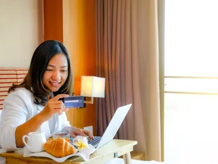 Traveller making secure hotel payment online from a hotel room with Arabiers Dubai support