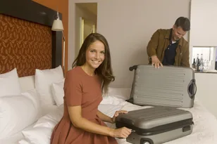 Travellers packing luggage in a hotel room for international hotel booking support by Arabiers UAE travel agency