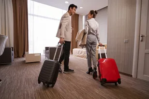 Travellers arriving with luggage in a hotel room for international hotel booking support by Arabiers UAE travel agency