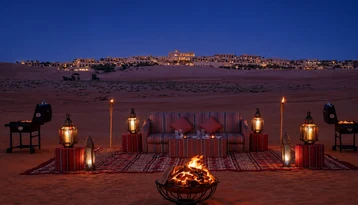 Private BBQ dinner experience at Qasr Al Sarab during a luxury Liwa desert day tour