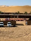 Traditional Abu Dhabi desert safari camp surrounded by dunes