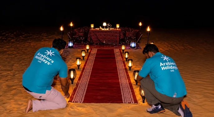 Private desert dinner camp setup prepared on the sand at Al Quaa