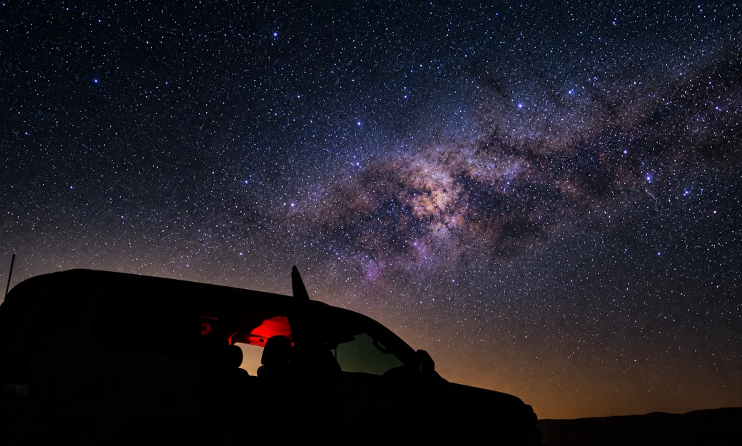 Private 4x4 parked beneath the Milky Way in the Al Quaa desert