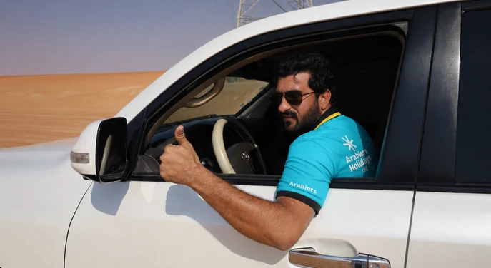 Arabiers driver in a private 4x4 for the Al Quaa desert camping transfer