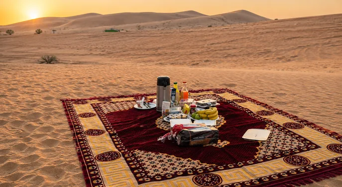 Outdoor breakfast prepared on a carpet in the Abu Dhabi desert