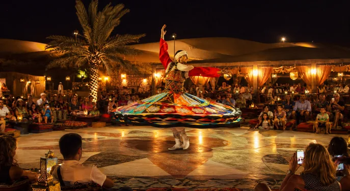 Guests watching a colourful live show at the Abu Dhabi desert camp