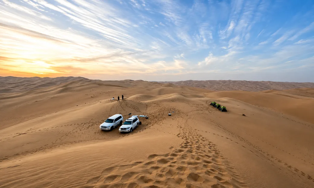 Private 4x4 vehicles and tents at an Abu Dhabi desert campsite