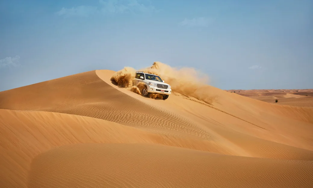 4x4 dune bashing across the high sand dunes in Abu Dhabi