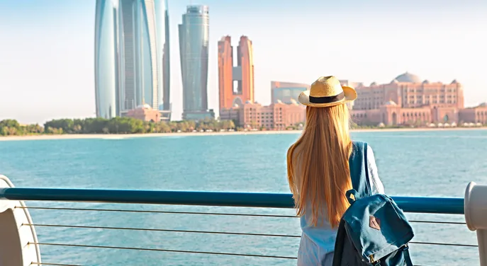 Traveller looking toward Emirates Palace from the Abu Dhabi Corniche