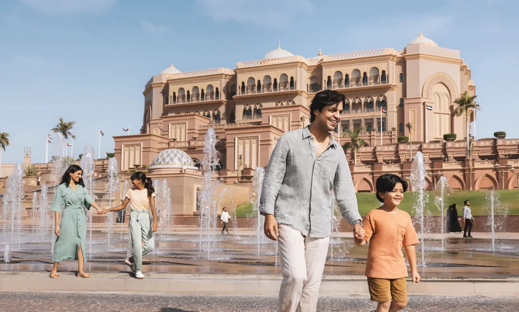 Family walking beside the fountains at Emirates Palace in Abu Dhabi