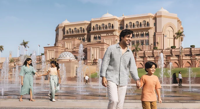 Family walking beside the fountains at Emirates Palace in Abu Dhabi