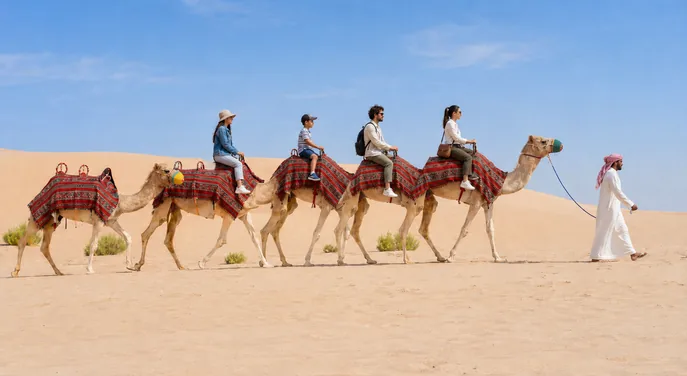 Families enjoying a handler-led camel trek in the Abu Dhabi desert