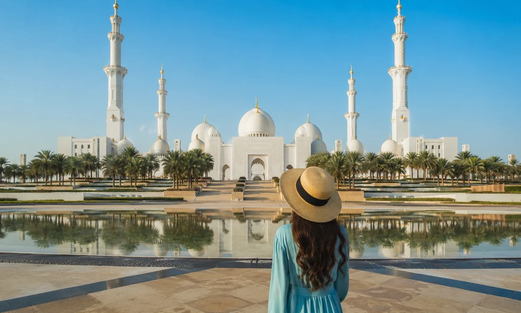 Visitor shuttle and guide outside Sheikh Zayed Grand Mosque