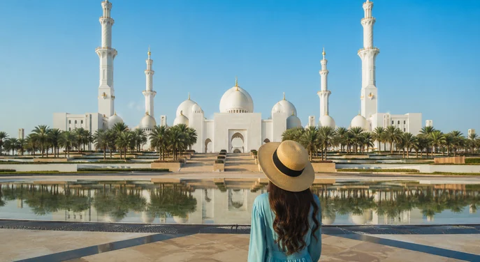 Visitor shuttle and guide outside Sheikh Zayed Grand Mosque