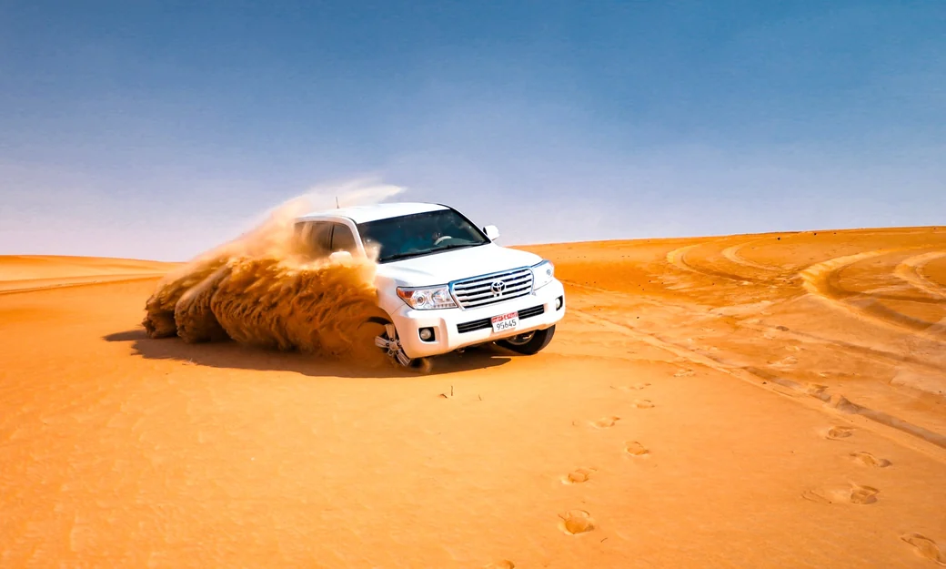 Toyota Land Cruiser dune bashing across the Liwa desert during a full day safari